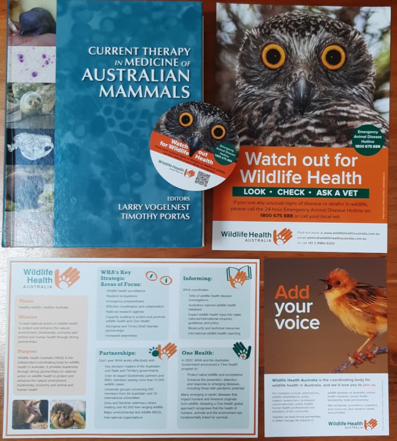 "Therapy in Medicine of Australian Mammals" book, and WHA stickers and brochures.
